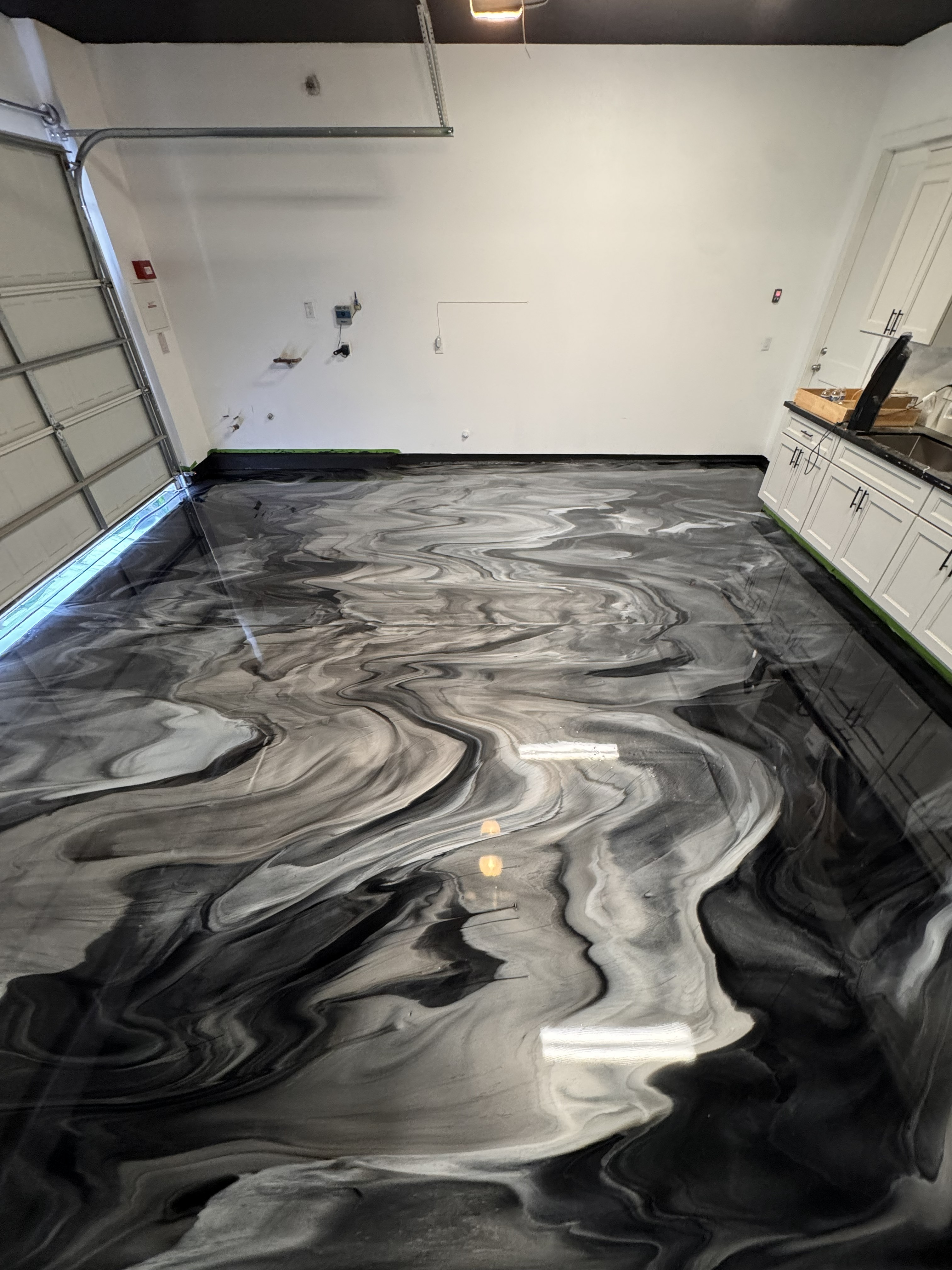Black and white swirl metallic epoxy garage